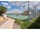 Well-maintained tennis court with secure fencing, surrounded by mature landscaping and community buildings at 8055 E Thomas Rd # 104, Scottsdale, AZ 85251