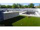 Backyard featuring lush artificial turf, a built-in BBQ, and an in-ground pool at 8156 E Questa Rd, Scottsdale, AZ 85255