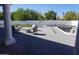 Outdoor patio with a modern fire pit, ample seating, and an in-ground pool for outdoor entertaining at 8156 E Questa Rd, Scottsdale, AZ 85255