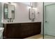 Bathroom showcasing a dual vanity with dark wood cabinets, white countertop, and black fixtures at 8156 E Questa Rd, Scottsdale, AZ 85255
