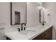 Modern bathroom features a double sink vanity, quartz countertops, and sleek, matte black fixtures at 8156 E Questa Rd, Scottsdale, AZ 85255