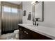Bathroom with modern vanity, matte black hardware, white countertops, and shower with curtain at 8156 E Questa Rd, Scottsdale, AZ 85255