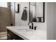 Modern bathroom features sleek white countertops and contemporary black fixtures for a stylish design at 8156 E Questa Rd, Scottsdale, AZ 85255