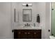 Modern bathroom features a single sink vanity, quartz countertops, and sleek, matte black fixtures at 8156 E Questa Rd, Scottsdale, AZ 85255
