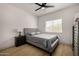 Comfortable bedroom with hardwood floors, gray headboard, nightstand, and window with blinds at 8156 E Questa Rd, Scottsdale, AZ 85255
