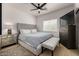 Bedroom with tufted headboard bed, mirrored nightstand, and chest of drawers, offering a tranquil retreat at 8156 E Questa Rd, Scottsdale, AZ 85255