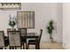 Dining room features stylish furnishings, hardwood floors, modern lighting fixture, and bright neutral color palette at 8156 E Questa Rd, Scottsdale, AZ 85255