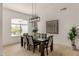 Elegant dining room showcasing a modern chandelier, dining table, and a view through an arched window at 8156 E Questa Rd, Scottsdale, AZ 85255