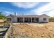 Back of home features white facade, covered patio, and spacious backyard at 8156 E Questa Rd, Scottsdale, AZ 85255