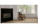 Cozy fireplace with decorative floral chair next to a window, allowing for a relaxing atmosphere at 8156 E Questa Rd, Scottsdale, AZ 85255