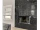 Granite fireplace features a gas insert and bright light from the window at 8156 E Questa Rd, Scottsdale, AZ 85255