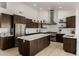 Fully equipped kitchen featuring state-of-the-art appliances and a central island at 8156 E Questa Rd, Scottsdale, AZ 85255
