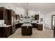 Contemporary kitchen offers wooden cabinetry, stainless hood, and expansive island at 8156 E Questa Rd, Scottsdale, AZ 85255