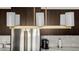 Close up view of lighting fixture with stainless refrigerator in the background at 8156 E Questa Rd, Scottsdale, AZ 85255