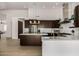 Bright open kitchen boasts stainless appliances, center island, and modern pendant lighting at 8156 E Questa Rd, Scottsdale, AZ 85255