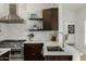 Beautiful kitchen details featuring tile backsplash, gold faucet, and stainless gas range at 8156 E Questa Rd, Scottsdale, AZ 85255