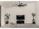 Open living room with a large TV, modern ceiling fan, and comfortable gray sectional, perfect for entertaining at 8156 E Questa Rd, Scottsdale, AZ 85255