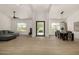 Spacious living area with wood floors, a dining table, a comfortable sofa, and high ceilings at 8156 E Questa Rd, Scottsdale, AZ 85255