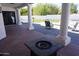 Covered patio area featuring modern design elements, an outdoor fire pit, and neutral color accents at 8156 E Questa Rd, Scottsdale, AZ 85255