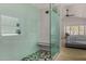 Modern walk-in shower features dual showerheads, stylish gray tile, and a built-in bench next to bedroom at 8156 E Questa Rd, Scottsdale, AZ 85255