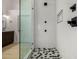 Bathroom featuring a glass shower with gray hexagonal tile floor and white marble walls at 8156 E Questa Rd, Scottsdale, AZ 85255