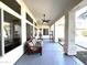 Covered back porch with ceiling fan, bench, and views of the landscaped backyard at 854 W Mesquite St, Gilbert, AZ 85233