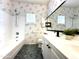 A bathroom featuring vanity with storage, a tub with shower and floral-patterned wallpaper at 854 W Mesquite St, Gilbert, AZ 85233