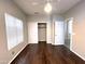 A bright bedroom featuring new hardwood floors, ceiling fan, window, and a closet at 854 W Mesquite St, Gilbert, AZ 85233
