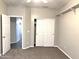 A bedroom featuring neutral-tone paint, carpet flooring, and a double door closet at 854 W Mesquite St, Gilbert, AZ 85233
