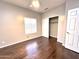 A bright bedroom featuring new hardwood floors, a window, and a closet at 854 W Mesquite St, Gilbert, AZ 85233