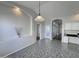 Bright dining area with tiled floors, an arched entryway, and a decorative light fixture at 854 W Mesquite St, Gilbert, AZ 85233