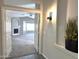 Neutral-toned entryway with ceramic tile and a partial view into an open living room with fireplace at 854 W Mesquite St, Gilbert, AZ 85233