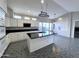 Modern kitchen with white cabinets, black countertops, and a large kitchen island at 854 W Mesquite St, Gilbert, AZ 85233