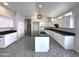 Modern kitchen with a large island, white cabinets, black countertops, and stainless steel appliances at 854 W Mesquite St, Gilbert, AZ 85233