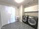Laundry room with washer, dryer, utility sink and white cabinets at 854 W Mesquite St, Gilbert, AZ 85233