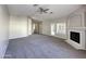 Spacious living room featuring a fireplace, ceiling fan, and neutral carpeting at 854 W Mesquite St, Gilbert, AZ 85233