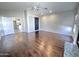 Open living room with hardwood floors, ceiling fan, and a view of the kitchen at 854 W Mesquite St, Gilbert, AZ 85233