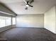 Neutral-toned living room with carpet, vaulted ceilings, and a large multi-paned window at 854 W Mesquite St, Gilbert, AZ 85233