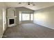 Neutral-toned living room with carpet, a fireplace, and a bay window at 854 W Mesquite St, Gilbert, AZ 85233