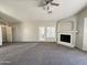 Open living room with a fireplace, ceiling fan, and access to the backyard at 854 W Mesquite St, Gilbert, AZ 85233