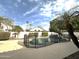 View of the fenced pool featuring a waterfall feature set amongst lush landscaping in a private backyard at 854 W Mesquite St, Gilbert, AZ 85233