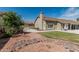 Exterior view of the backyard with a well-maintained lawn, patio, and drought-resistant landscaping at 921 N Oxford Ln, Chandler, AZ 85225