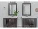 Bathroom featuring dual sinks, dark wood cabinetry, stylish faucets, and modern mirrors at 921 N Oxford Ln, Chandler, AZ 85225