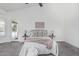 Bright bedroom with vaulted ceilings, two side tables, and door to the outside at 921 N Oxford Ln, Chandler, AZ 85225
