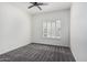 Bright bedroom featuring plantation shutters, neutral carpet, and a modern ceiling fan at 921 N Oxford Ln, Chandler, AZ 85225