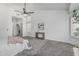 Spacious bedroom features a vaulted ceiling, modern ceiling fan and transom window at 921 N Oxford Ln, Chandler, AZ 85225