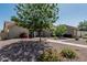 Charming home with desert landscaping, mature shade trees, and a quaint walkway to the front door at 921 N Oxford Ln, Chandler, AZ 85225