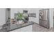 The kitchen features sleek stainless steel appliances, gray granite countertops, and stylish mosaic backsplash at 921 N Oxford Ln, Chandler, AZ 85225
