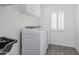 Laundry room featuring newer washer and dryer, painted white walls, and matching cabinets above at 921 N Oxford Ln, Chandler, AZ 85225