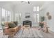 Bright living room with a fireplace, high ceilings and large windows with natural light at 921 N Oxford Ln, Chandler, AZ 85225